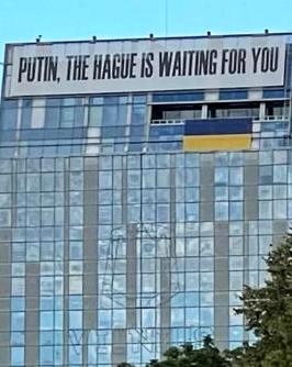 On this photo: A building in central Vilnius, Lithuania, displays an anti-Putin message above the Ukrainian flag — BBC News.