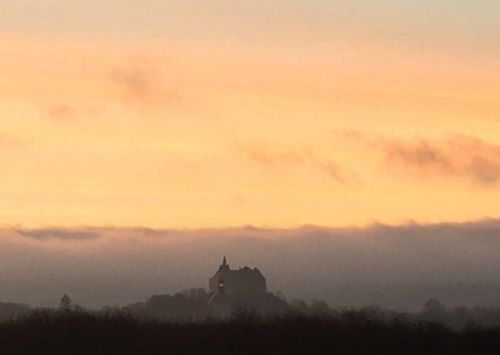 Olesko Castle. Olesko Castle (Ukrainian: Олеський замок, Polish: Zamek w Olesku) is located within the borders of present-day Zolochiv Raion in Ukraine. The first historical records of the castle are in a document dated 1390, when Pope Boniface IX gave Olesko and Tustan to a Catholic bishop of Halych. It is located about seventy-five kilometers from Lviv, the largest city in western Ukraine.