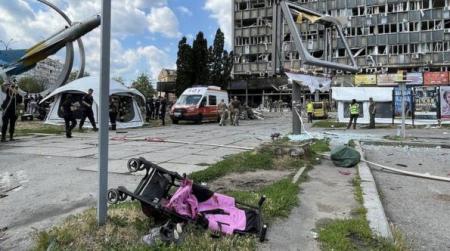Liza's pushchair lies on its side outside the ruins of the Jubilee building on 14 July — BBC News.